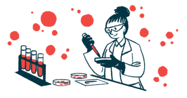 A scientist conducts tests using a petri dish in a laboratory, alongside a rack of four filled vials.