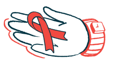 An awareness ribbon is seen on a person's palm.