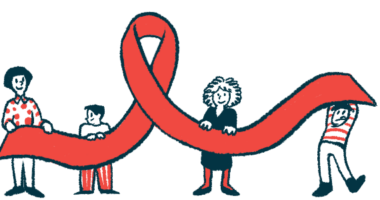 Four people hold up a large awareness ribbon.